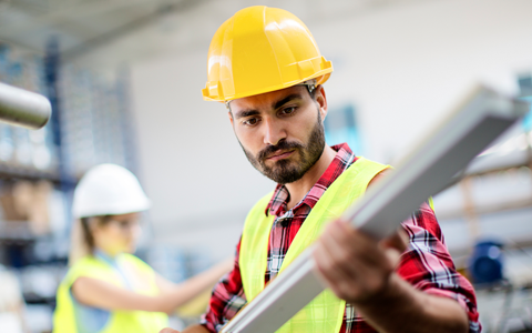Employee working in hard hat and high vis vest