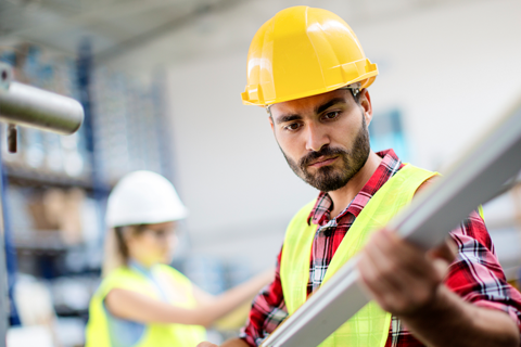 Employee working in hard hat and high vis vest