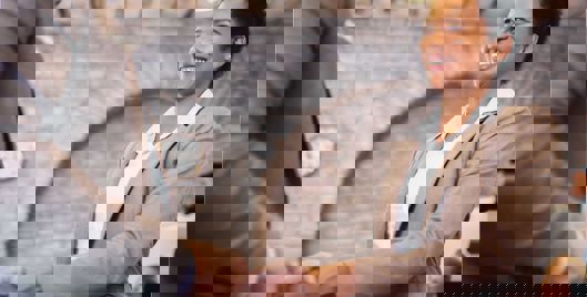 Woman smiling shaking someones hand