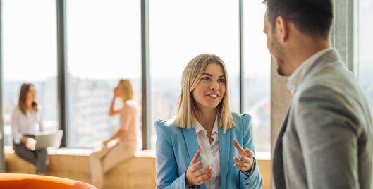 Woman talking to man in office