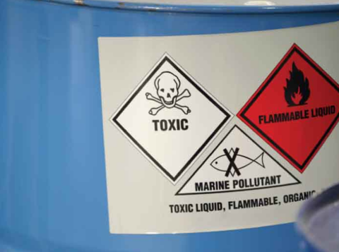 Blue vat of chemicals labelled toxic, flammable liquid and marine pollutant